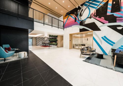 An image of the newly renovated and redeveloped Carson Station office lobby with a backdrop of Uptown Charlotte. Leasing by The Spectrum Companies.
